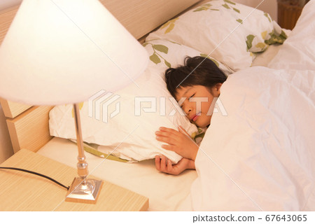 A girl sleeping in bed A girl sleeping in bed 67643065