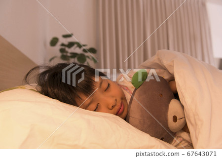 A girl sleeping in bed 67643071