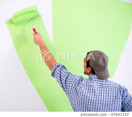 Young painter doing renovation at home Young painter doing renovation at home 67643187