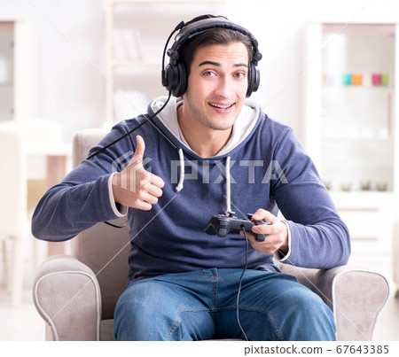 Young man playing computer games at home 67643385