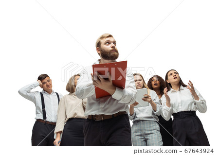Nervous tensioned investors analyzing crisis stock market with charts on screen of their gadgets 67643924