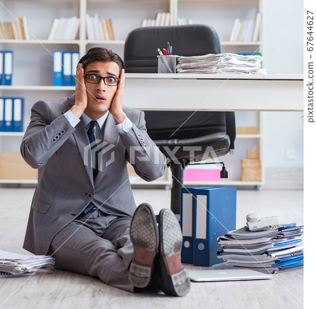 Businessman working and sitting on floor in office Businessman working and sitting on floor in office 67644627