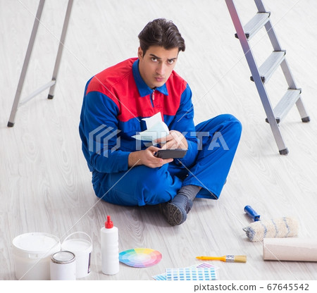 Young painter trying to match colours for painting job Young painter trying to match colours for painting job 67645542