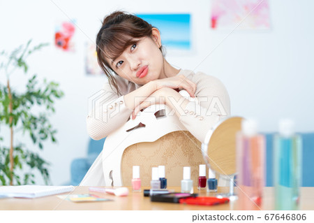 Portrait of smiling young woman looking at camera in living room at home Portrait of smiling young woman looking at camera in living room at home 67646806