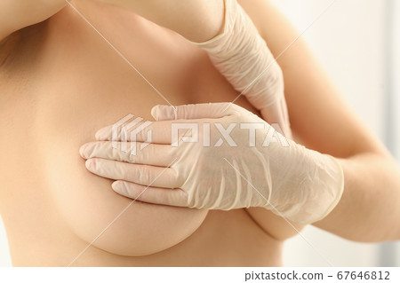 Topless woman doing breast check up with hands Topless woman doing breast check up with hands 67646812