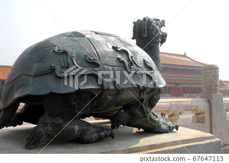 Forbidden City, Beijing, China. Bronze statue of a turtle inside the Forbidden City. The Forbidden City has traditional Chinese architecture. The Forbidden City is also the Palace Museum, Beijing. 67647113