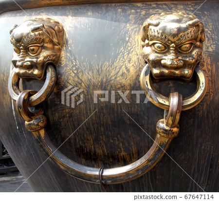 Forbidden City, Beijing, China. A bronze urn for fire control in the Forbidden City. The Forbidden City has traditional Chinese architecture. The Forbidden City is also the Palace Museum, Beijing. 67647114