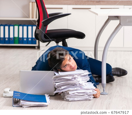 Tired exhausted businessman working overtime in office 67647917