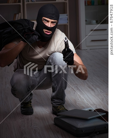 Burglar wearing balaclava mask at crime scene Burglar wearing balaclava mask at crime scene 67647918