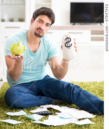 Young man struggling with personal finance and bills Young man struggling with personal finance and bills 67647919