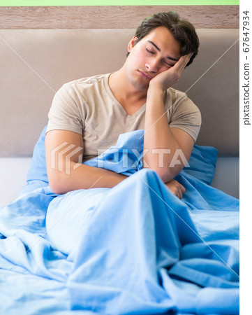 Man having trouble with his sleep Man having trouble with his sleep 67647934