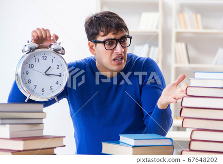 Male student preparing for exams in college library Male student preparing for exams in college library 67648202