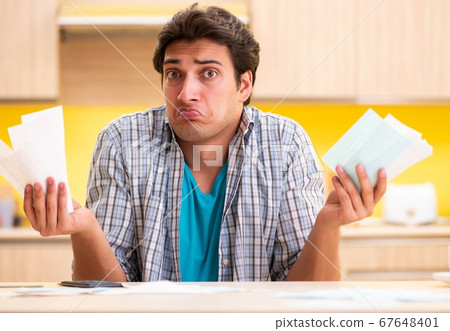 Young man husband in budget planning concept Young man husband in budget planning concept 67648401