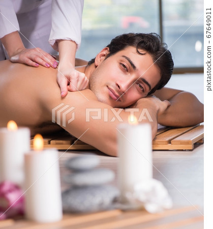 Young handsome man during spa procedure Young handsome man during spa procedure 67649011