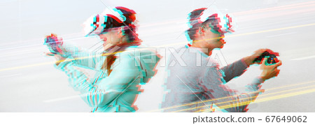 Man and woman with virtual reality headset are playing game. Image with glitch effect. 67649062