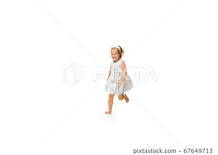Happy little caucasian girl jumping and running isolated on white background Happy little caucasian girl jumping and running isolated on white background 67649713