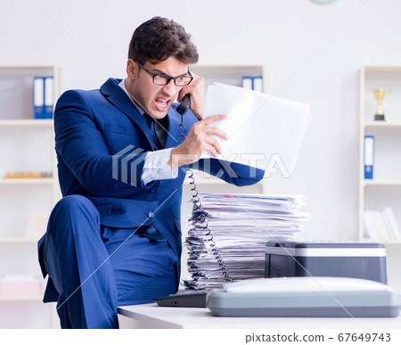 Businessman making copies in copying machine Businessman making copies in copying machine 67649743