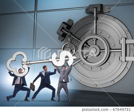 Businessman with key near bank vault door 67649781