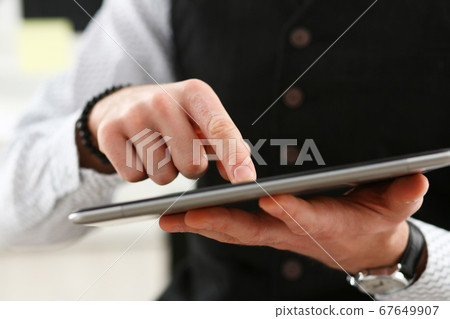 Close up of businessman that using new tablet 67649907