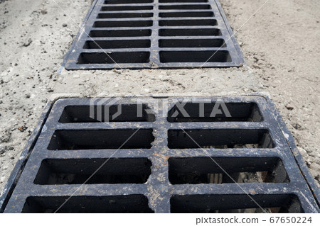 New rainwater grate on the road or sidewalk, 67650224
