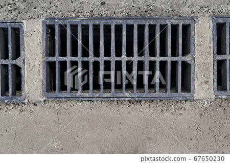 New rainwater grate on the road or sidewalk, New rainwater grate on the road or sidewalk, 67650230