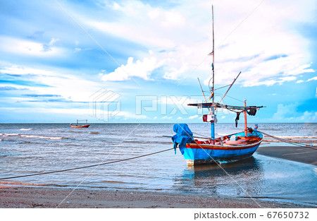 Blue small fishing boat moor on the beach after Blue small fishing boat moor on the beach after 67650732