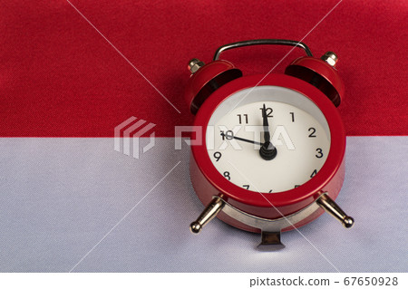 Poland flag and vintage alarm clock on close up. 67650928