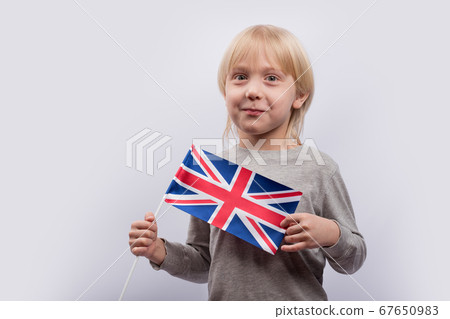 Exciting fair-haired boy holding flag of UK. 67650983