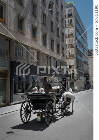 Traditional Fiaker Horse Carriage With Coachman As Sightseeing Tour Guide In The Streets Of Vienna In Austria Traditional Fiaker Horse Carriage With Coachman As Sightseeing Tour Guide In The Streets Of Vienna In Austria 67651190