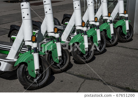 Rental Electric Scooters, e-scooter, Parked In Group On The Pavement 67651200