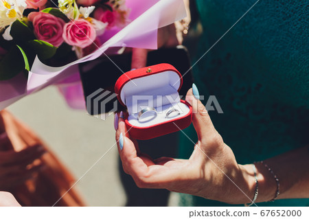 Close up of man holding wedding ring and gift box. Close up of man holding wedding ring and gift box. 67652000