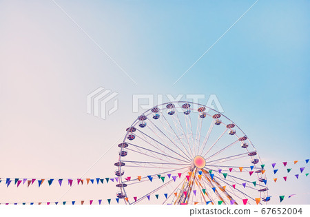 Ferris wheel with cloudless sky in background. Ferris wheel with cloudless sky in background. 67652004