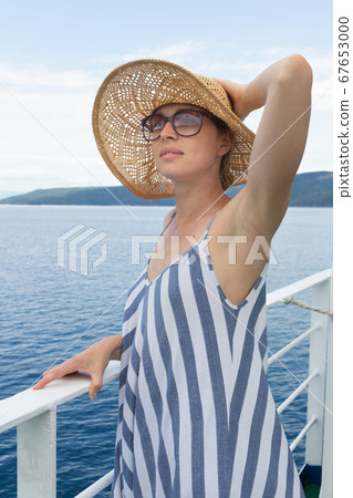 Beautiful, romantic blonde woman taking selfie self portrait photo on summer vacations traveling by cruse ship ferry boat. Beautiful, romantic blonde woman taking selfie self portrait photo on summer vacations traveling by cruse ship ferry boat. 67653000