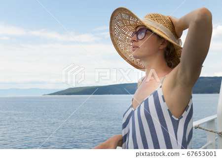 Beautiful, romantic blonde woman taking selfie self portrait photo on summer vacations traveling by cruse ship ferry boat. Beautiful, romantic blonde woman taking selfie self portrait photo on summer vacations traveling by cruse ship ferry boat. 67653001