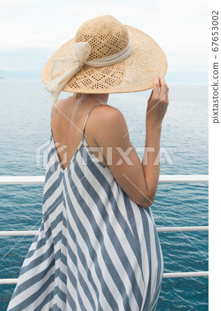 Beautiful, romantic blonde woman taking selfie self portrait photo on summer vacations traveling by cruse ship ferry boat. Beautiful, romantic blonde woman taking selfie self portrait photo on summer vacations traveling by cruse ship ferry boat. 67653002