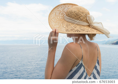 Beautiful, romantic blonde woman taking selfie self portrait photo on summer vacations traveling by cruse ship ferry boat. Beautiful, romantic blonde woman taking selfie self portrait photo on summer vacations traveling by cruse ship ferry boat. 67653003