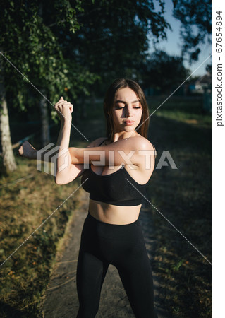 Fit woman stretching hands during outdoor training Fit woman stretching hands during outdoor training 67654894