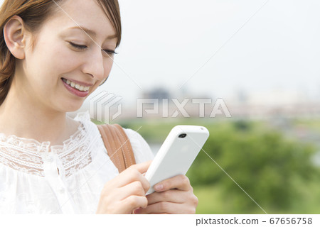 Woman looking at mobile mail Woman looking at mobile mail 67656758