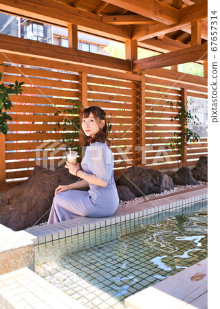 Young woman bathing in footbath Young woman bathing in footbath 67657314