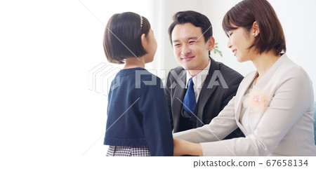 Girl in suit and parents entrance ceremony Graduation ceremony 67658134