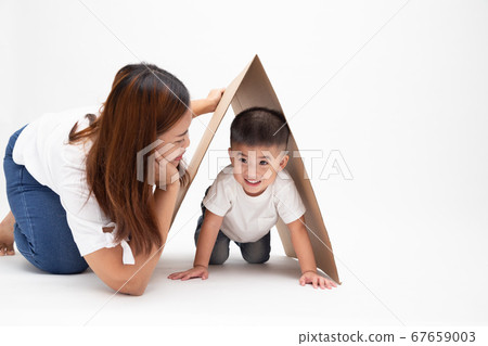 Asian mother playing with son and smiling while spending free time 67659003
