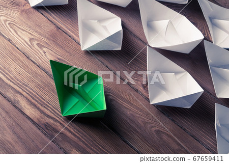 Business leadership concept with white and color paper boats on 67659411