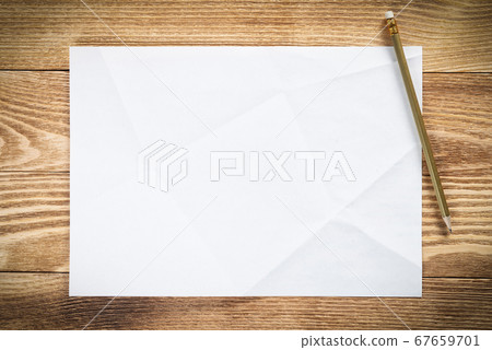 Sheet of paper lying on wooden table Sheet of paper lying on wooden table 67659701