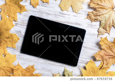 Tablet computer with blank screen on desk Tablet computer with blank screen on desk 67659738