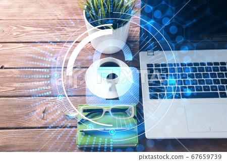 Business workplace with laptop coffee cup and security concept on screen 67659739