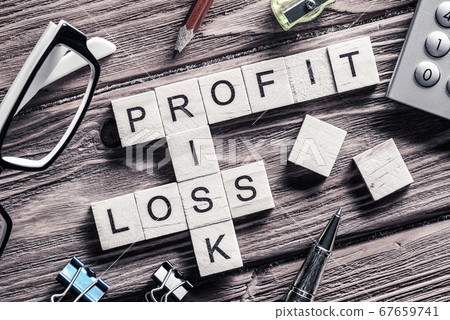 Profit loss and risk words on workplace collected of wooden cube Profit loss and risk words on workplace collected of wooden cube 67659741