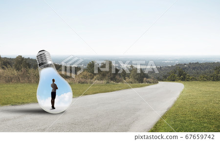 Businesswoman inside light bulb Businesswoman inside light bulb 67659742