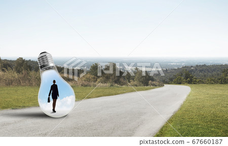 Businesswoman inside light bulb Businesswoman inside light bulb 67660187