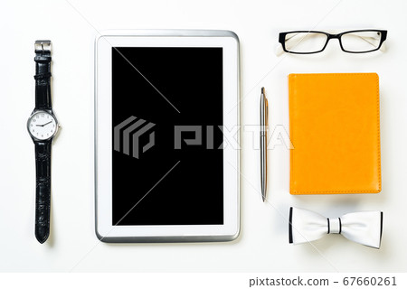 Gentleman kit of tablet watch glasses bow tie and notebook on wooden table 67660261