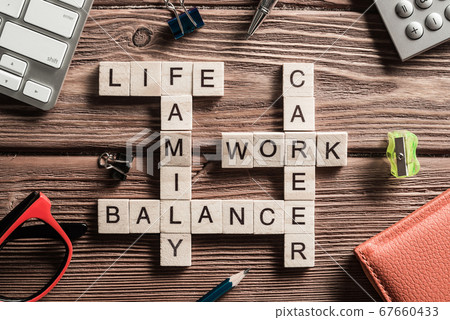 Conceptual keywords on wooden table with elements of game making crossword 67660433